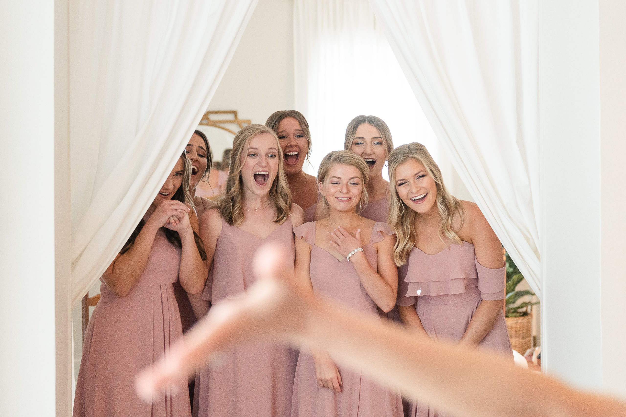 Excited and happy first look with bridesmaids and bride