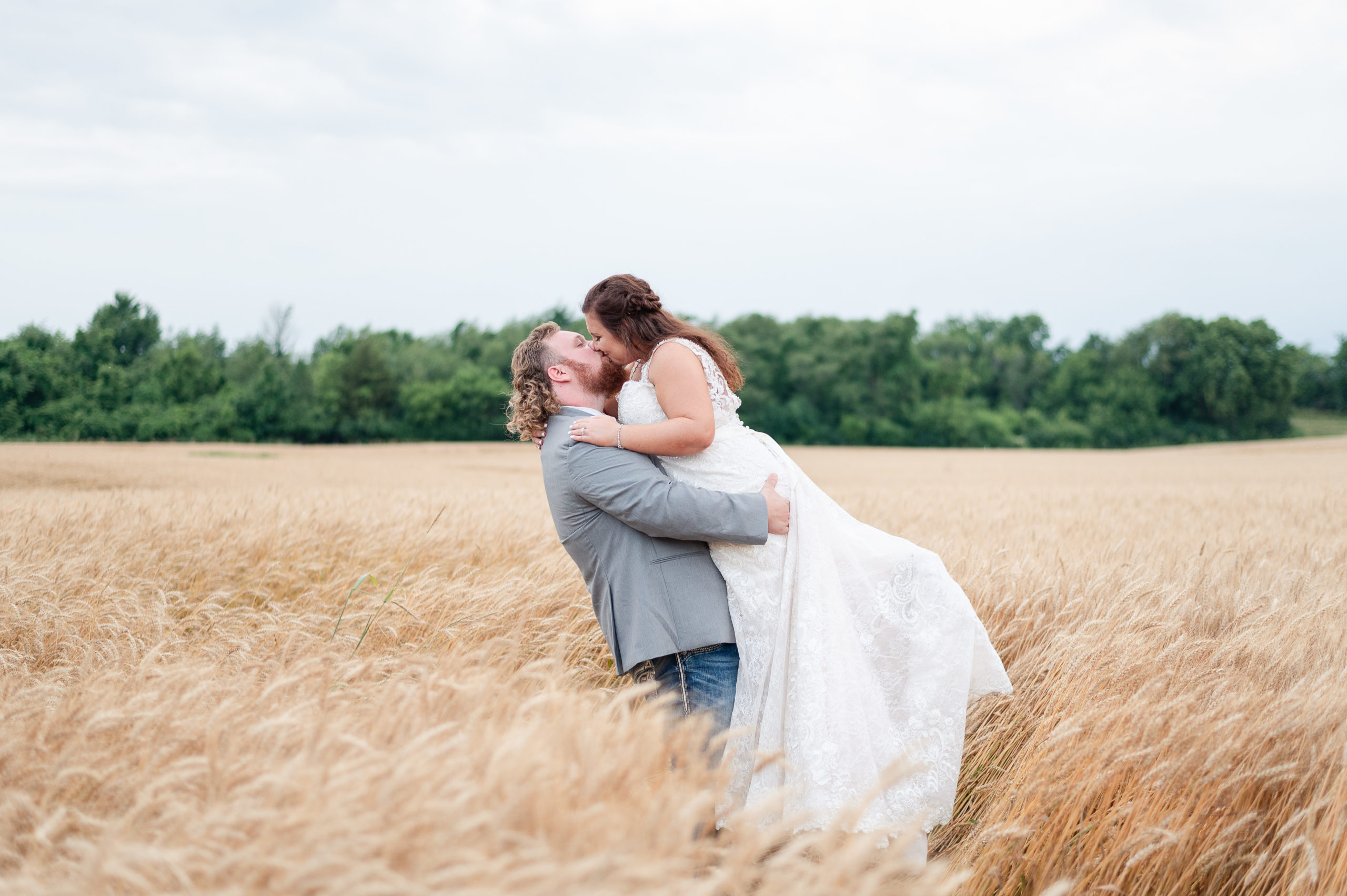 The Old Gray Barn in Frankfort, IN | Khyla & Jake Goodman Married! Bride being lifted up in the air by her husband and kissing in the wheat field. 