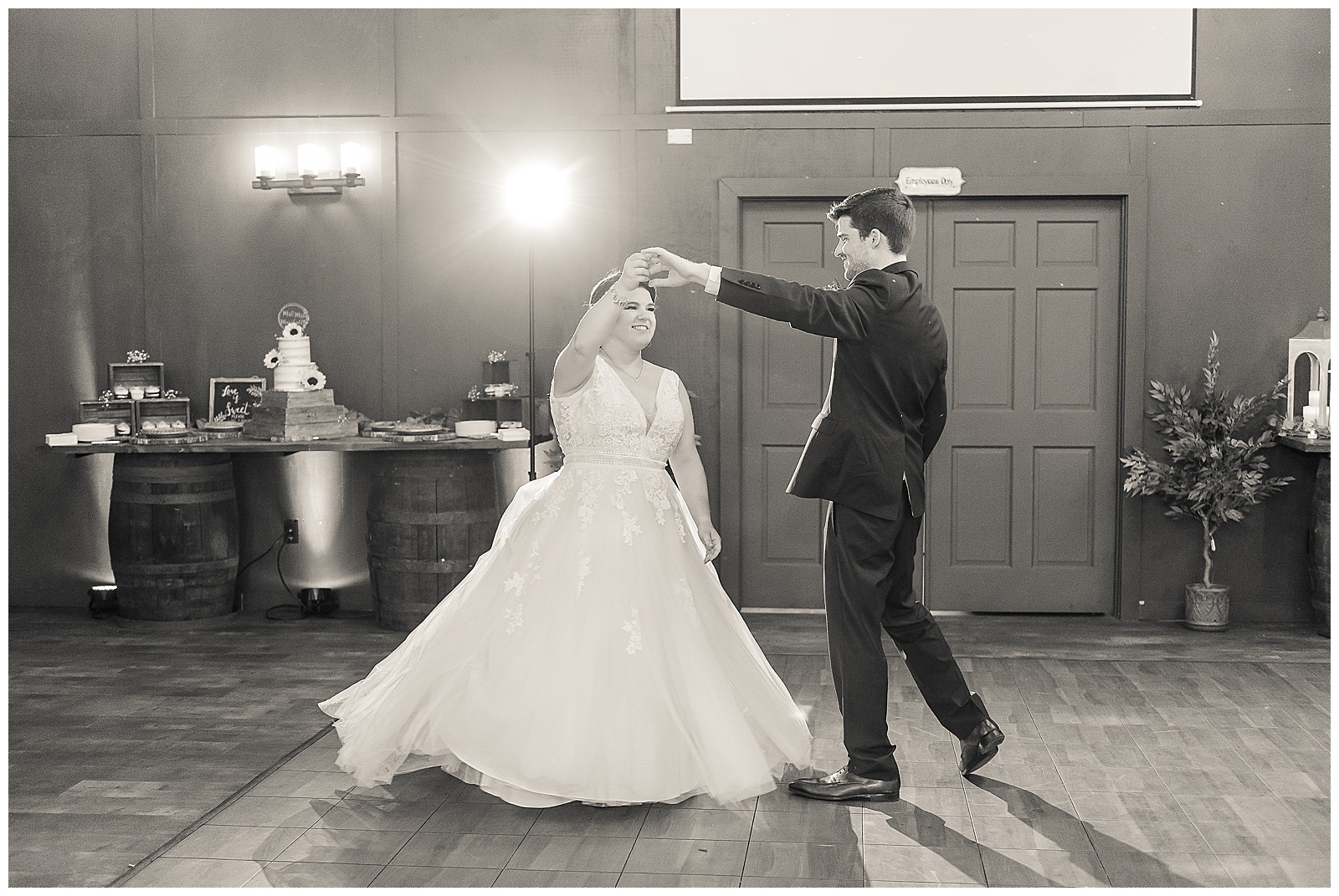 Groom twirling his bride during their first dance 