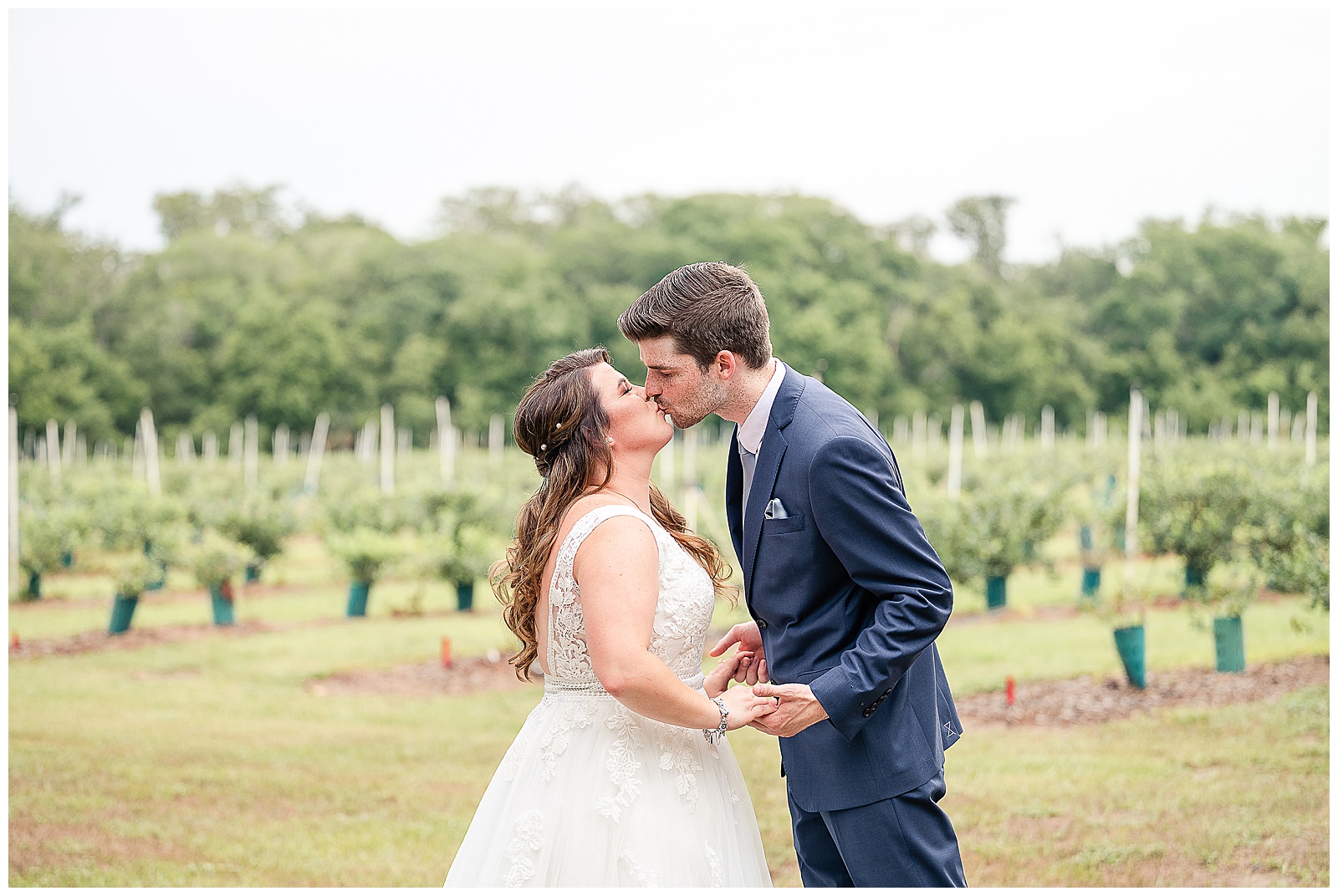Bride and Groom kissing at their First Look at a Wedding at Ever After Farms Blueberry Barn 