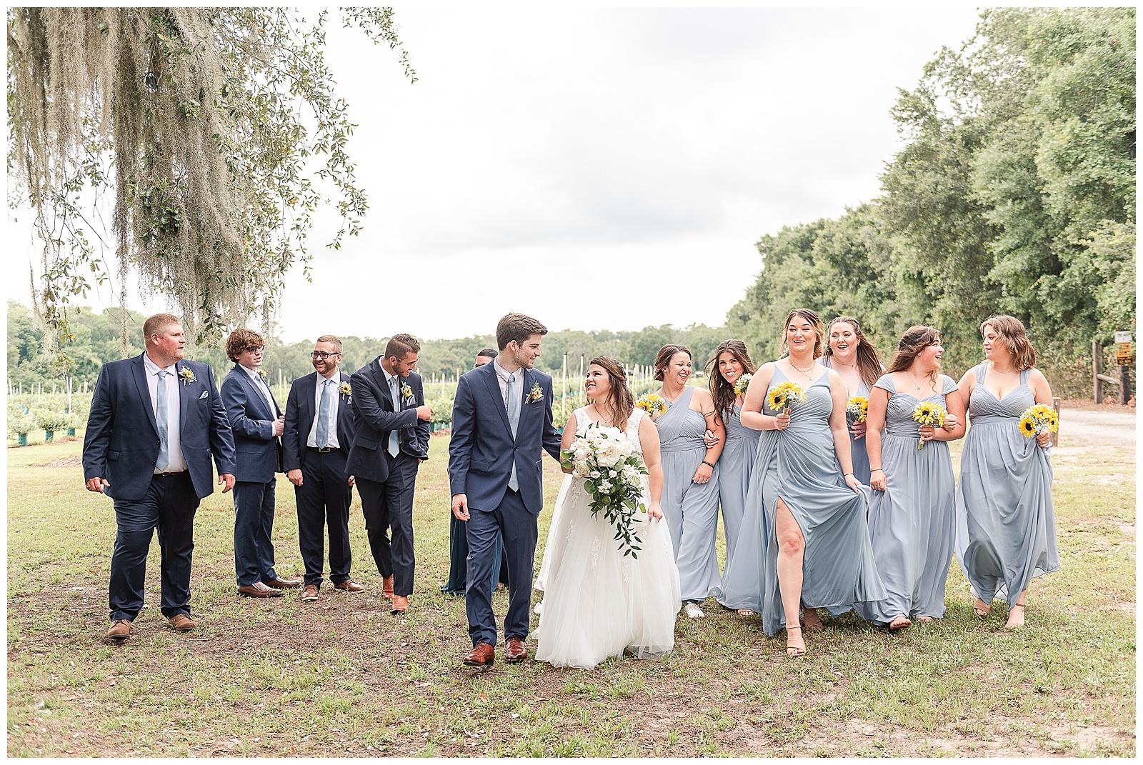 The Bridal party walking toward the camera laughing at one another 