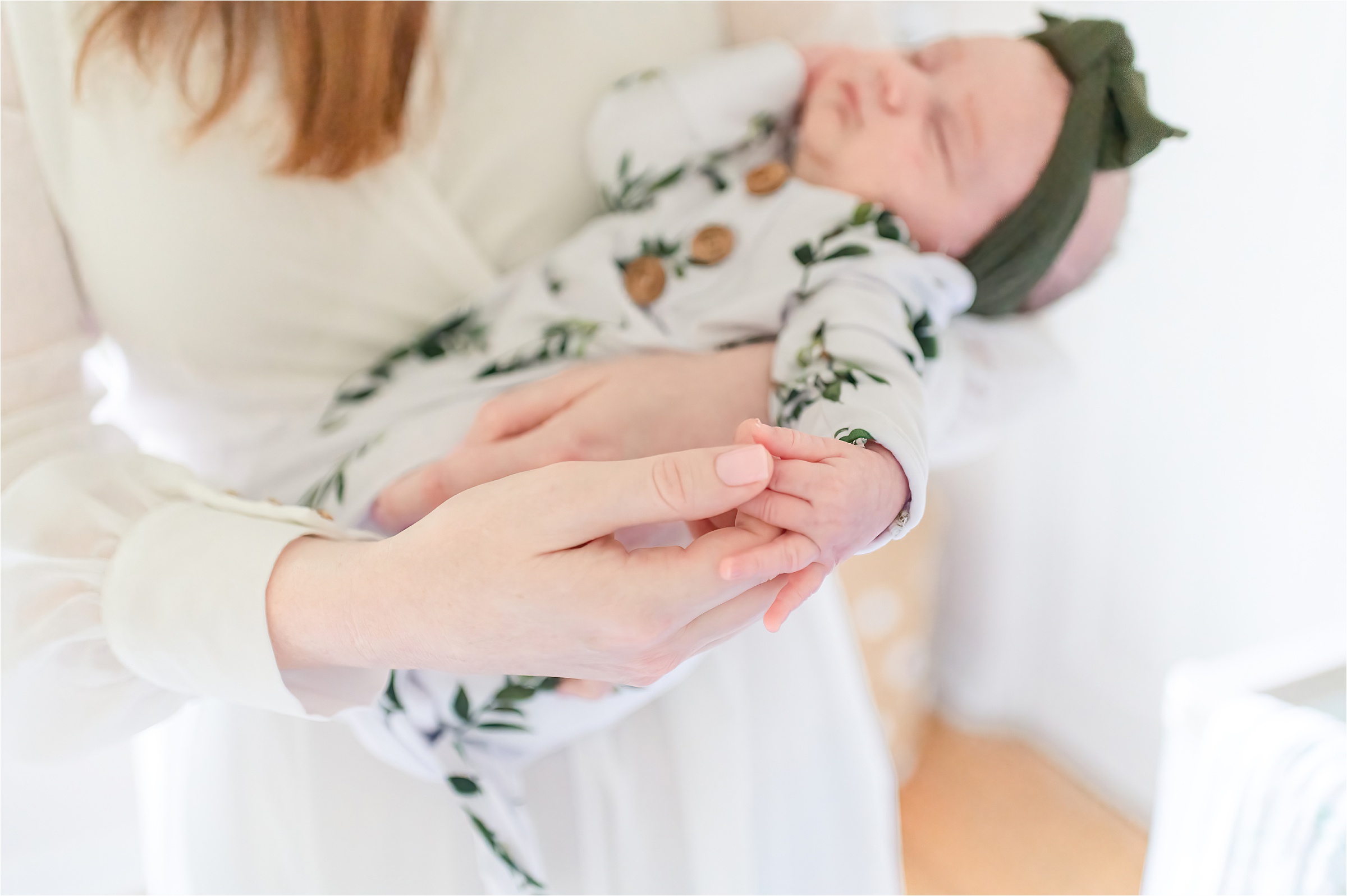 Mom touching her baby's hand | Lifestyle Newborn Photography