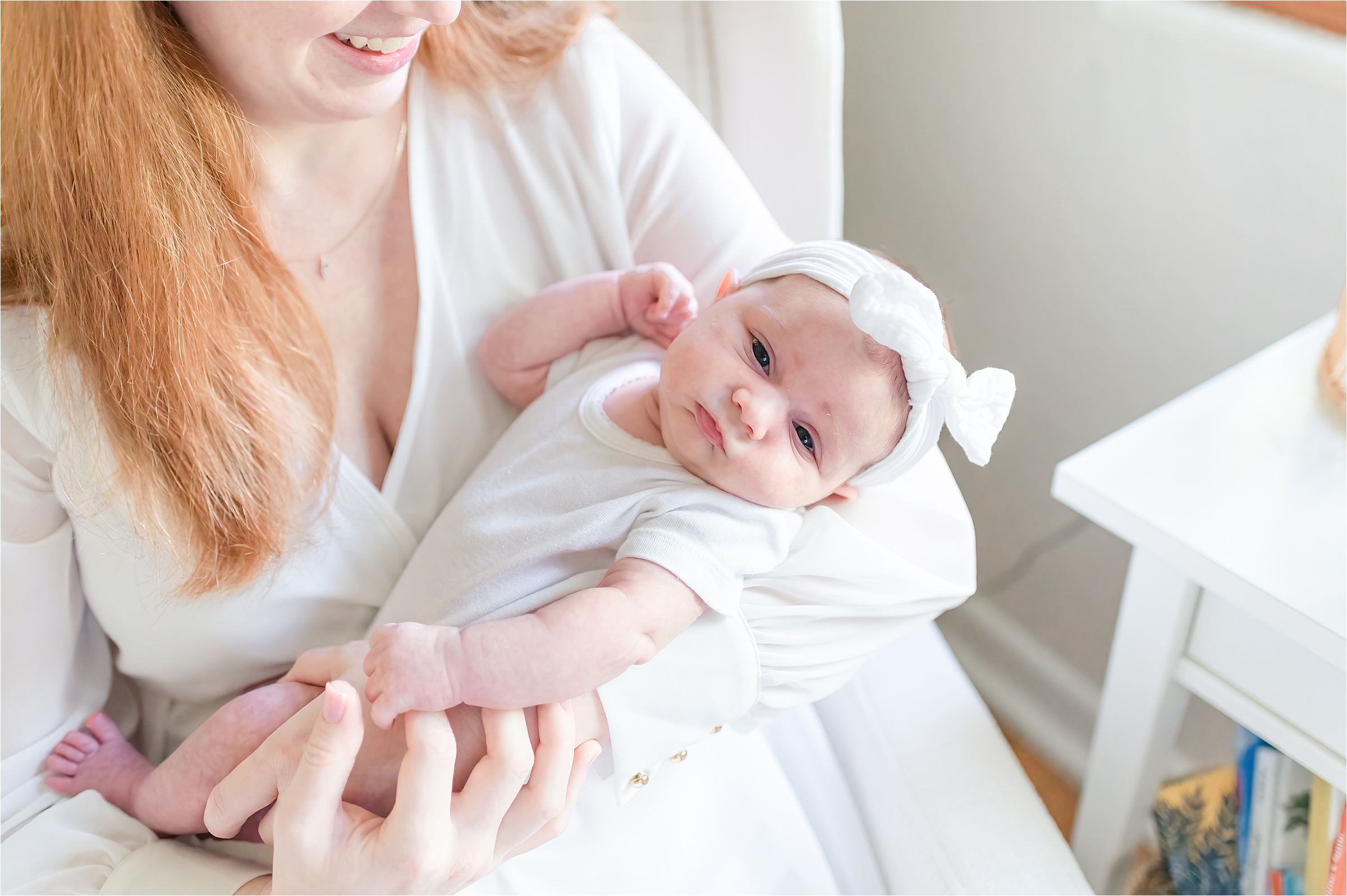 Mom holding baby in the glider | Lifestyle Newborn Photography