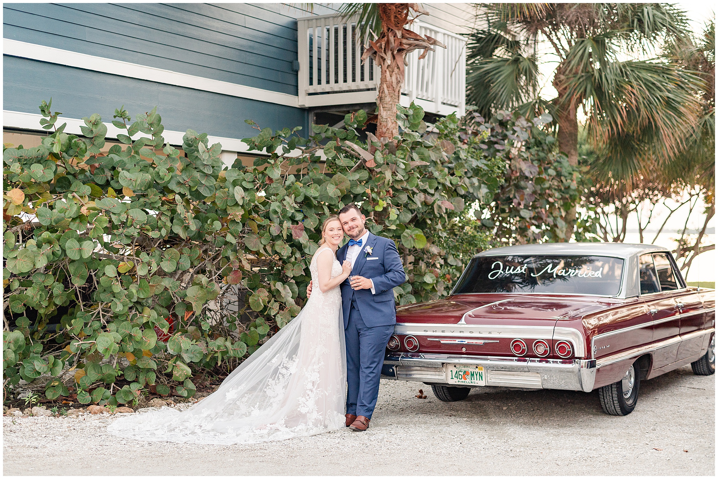 Bride and groom posing with old chevy car at their wedding at Tampa Bay Watch