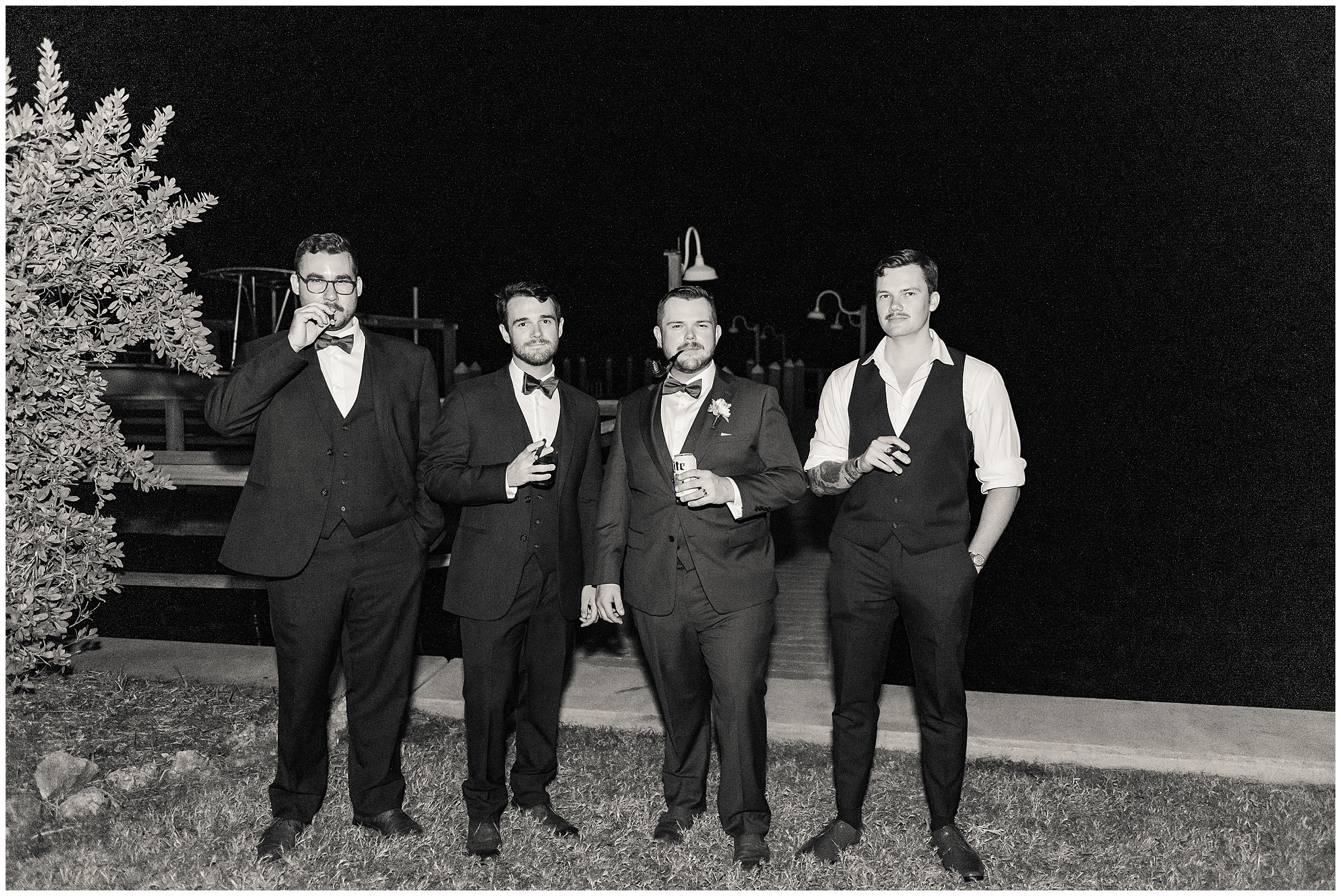 Groom and groomsmen enjoying cigars our by the boat docks  at Tampa Bay Watch Wedding in Tierra Verde, FL