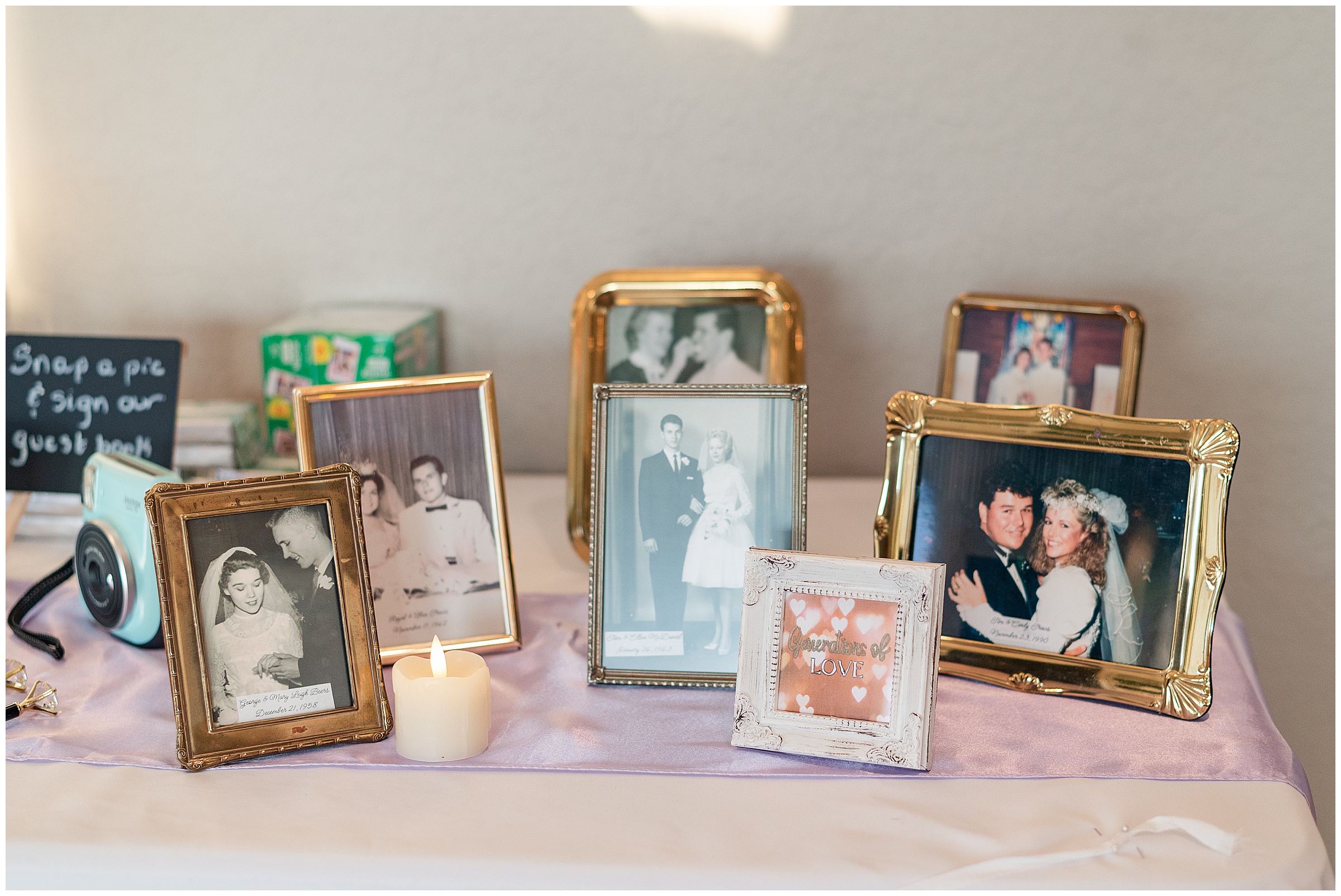 Old wedding photos from bride and grooms family members displayed on a  table at the reception