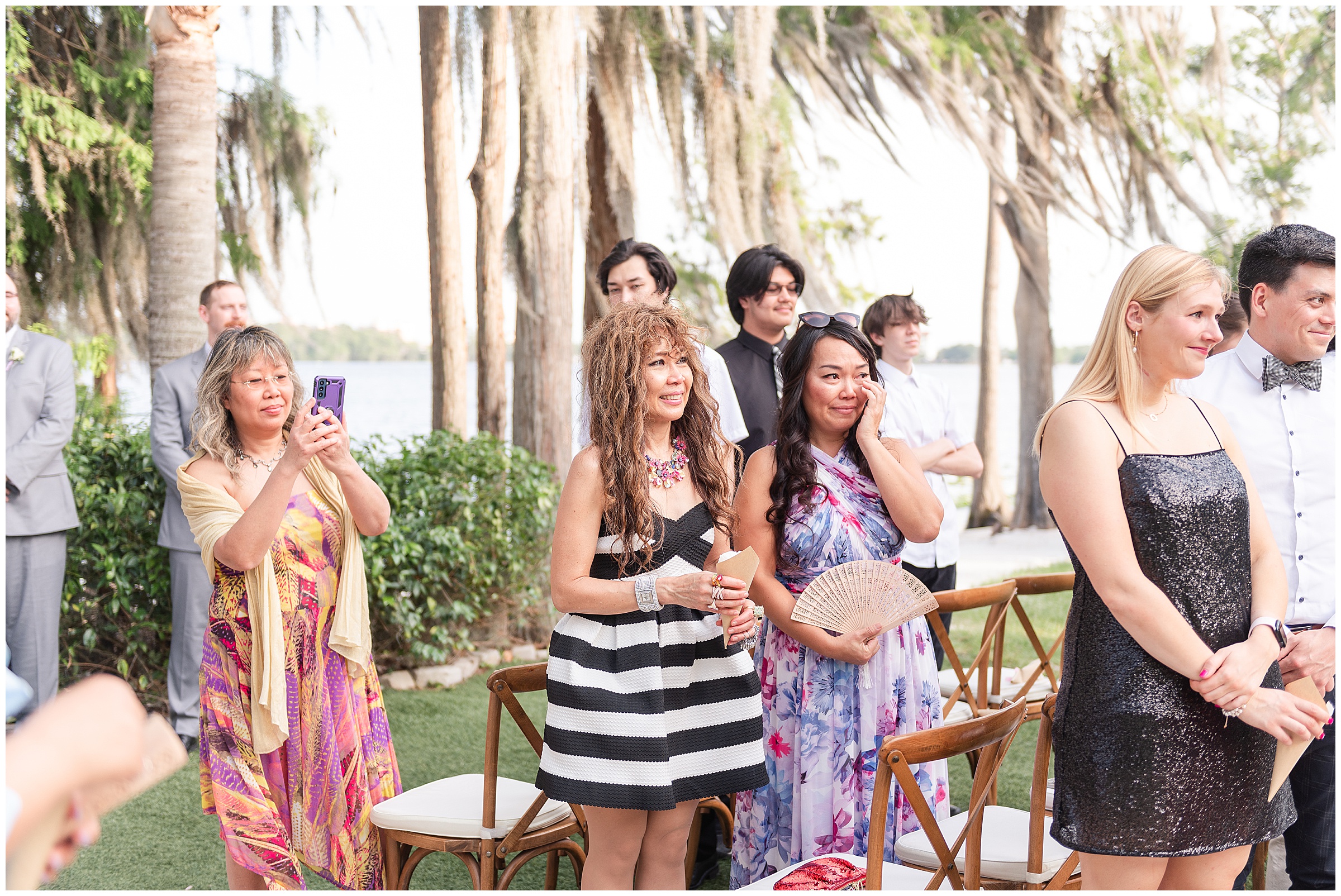 Wedding guests watching the bride walk down the aisle at a Paradise Cove Wedding in Orlando, FL