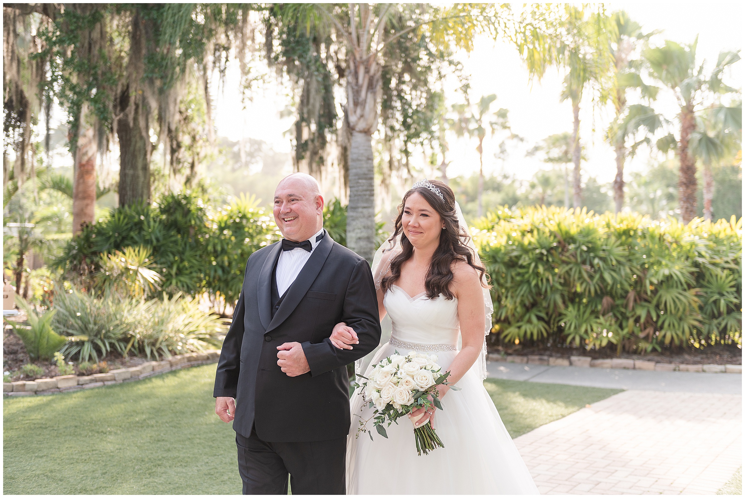 Bride and father walking down the ceremony aisle at a Paradise Cove Wedding in Orlando, FL