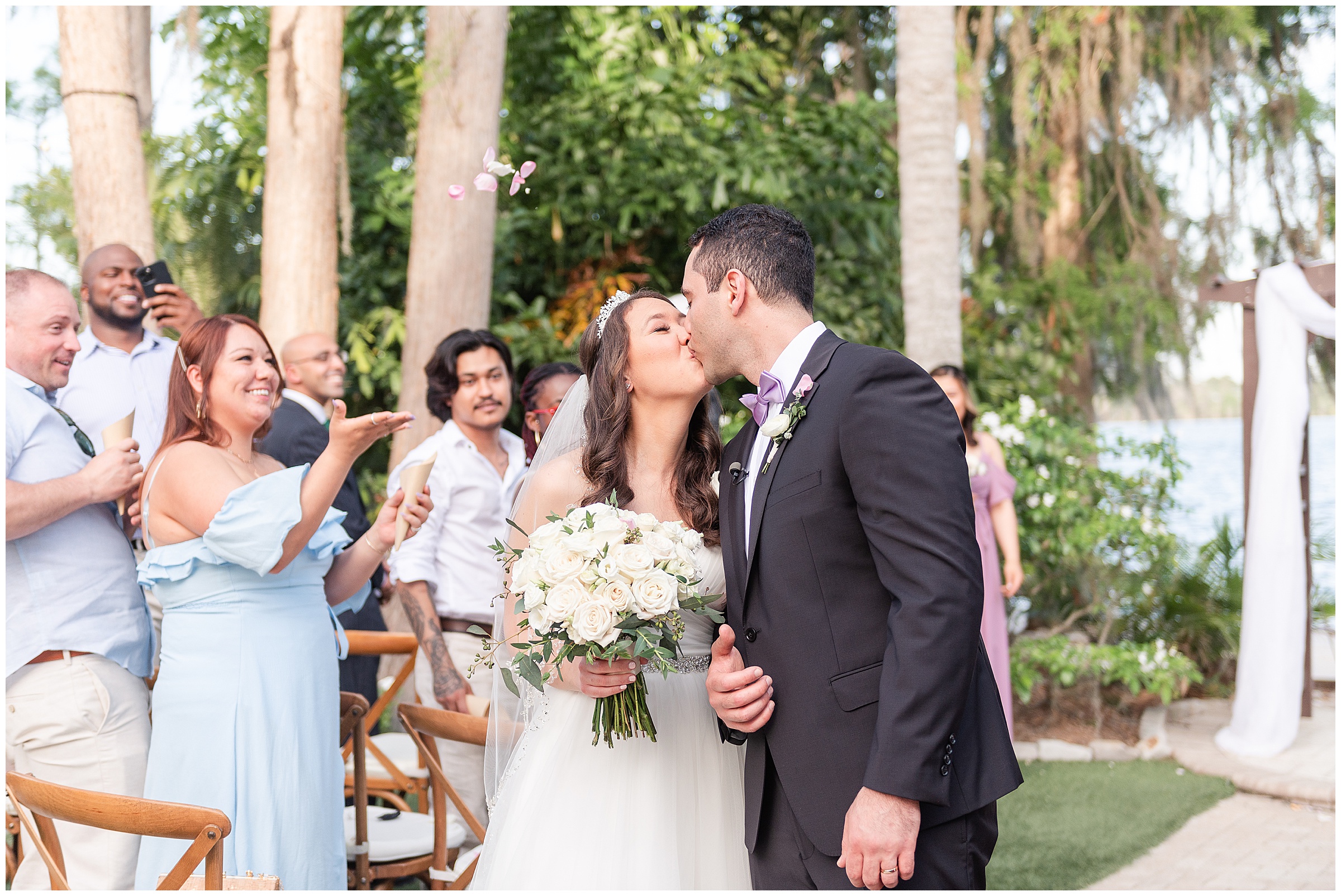 Bride and groom kiss at a Paradise Cove Wedding in Orlando, FL