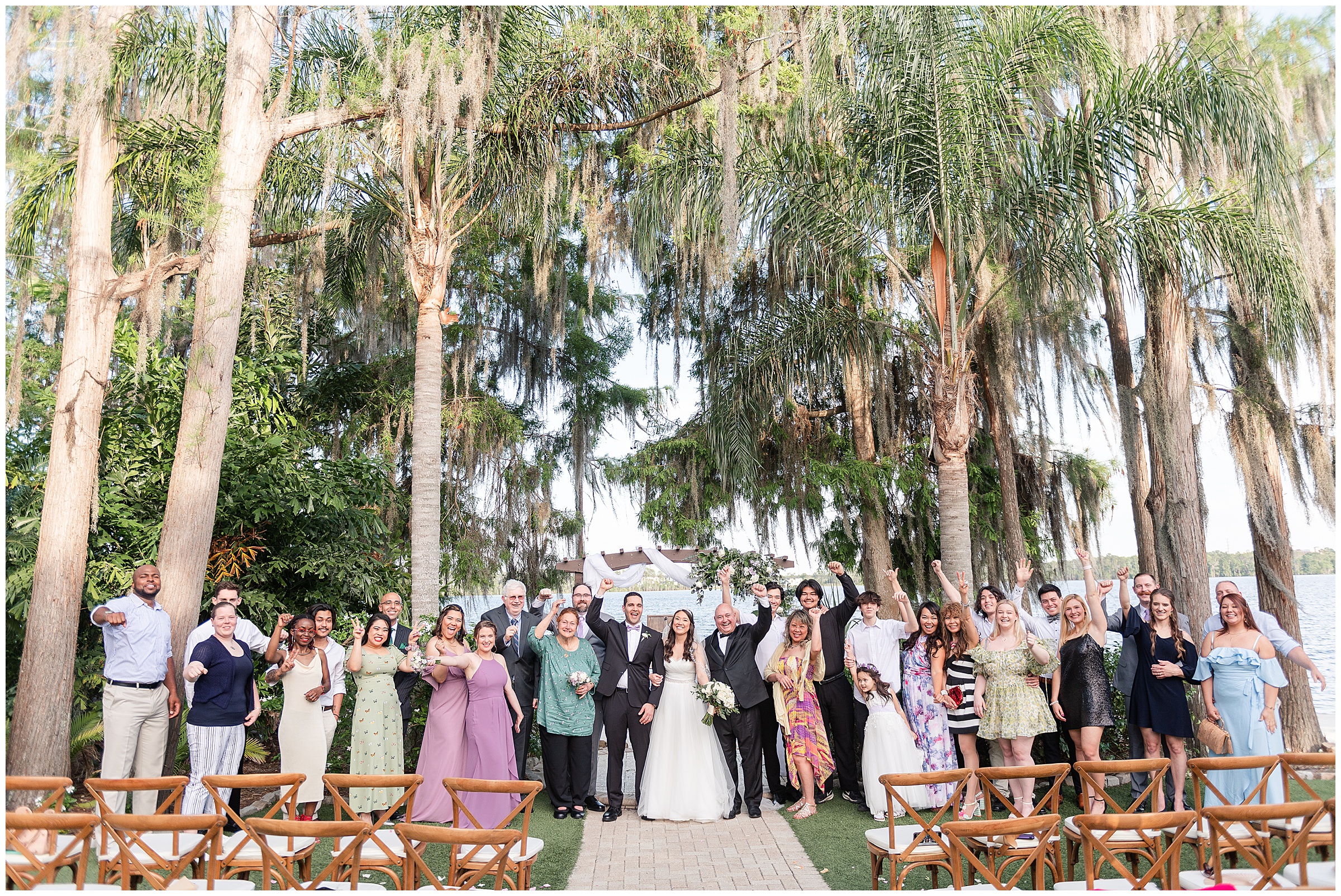 Large family photo with everyone cheering at a Paradise Cove Wedding in Orlando, FL