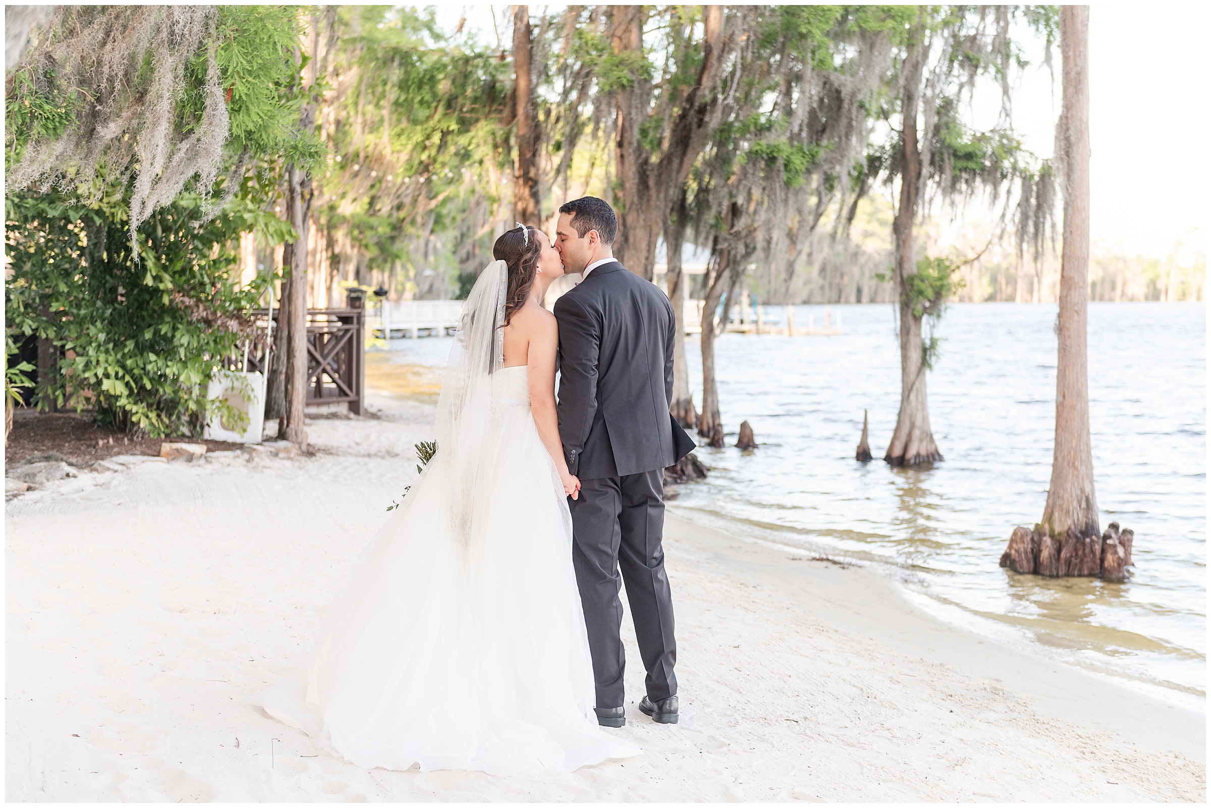 Bride and groom photos on the beach at their Paradise Cove Wedding in Orlando, FL