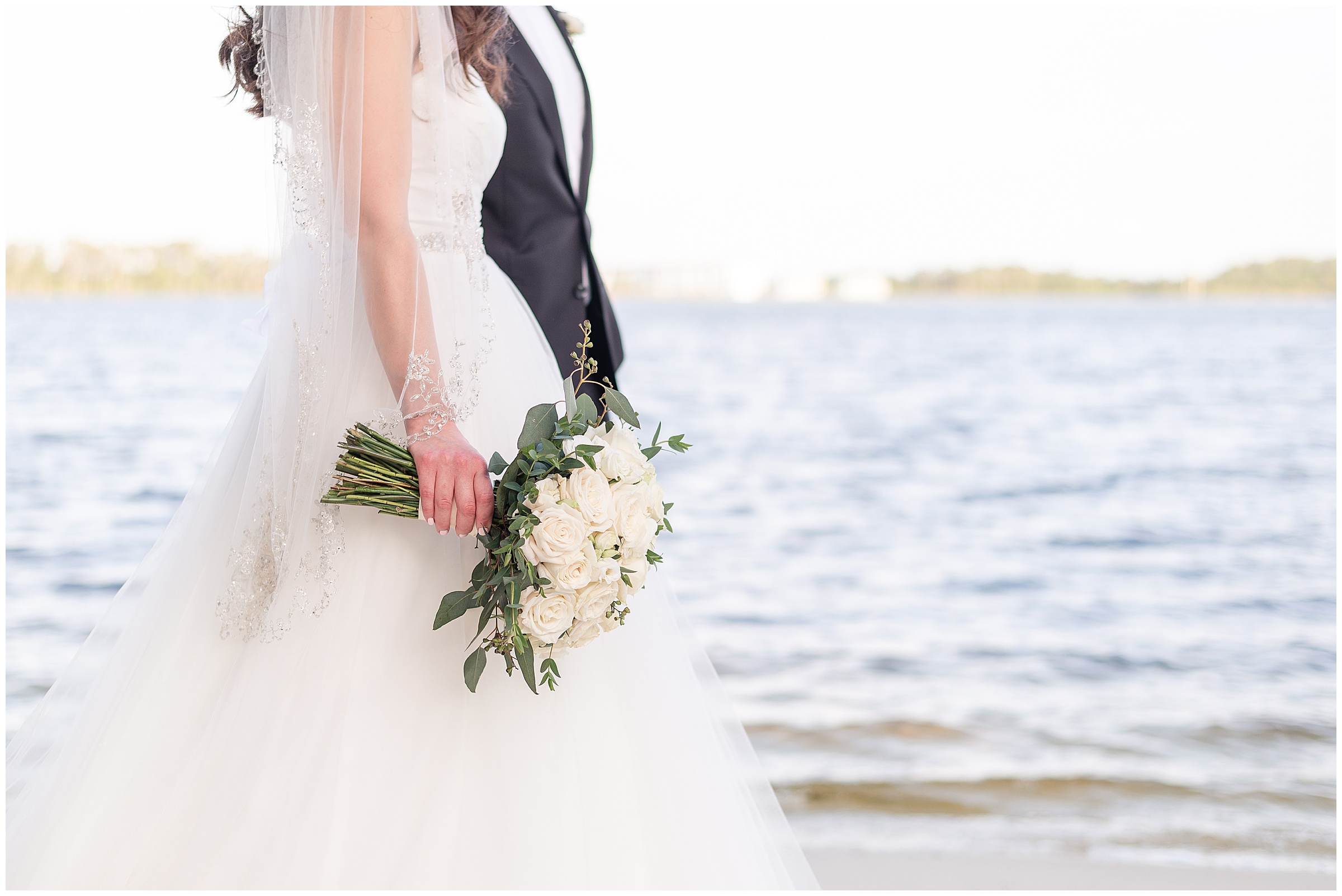 Bride and groom photos on the beach at their Paradise Cove Wedding in Orlando, FL