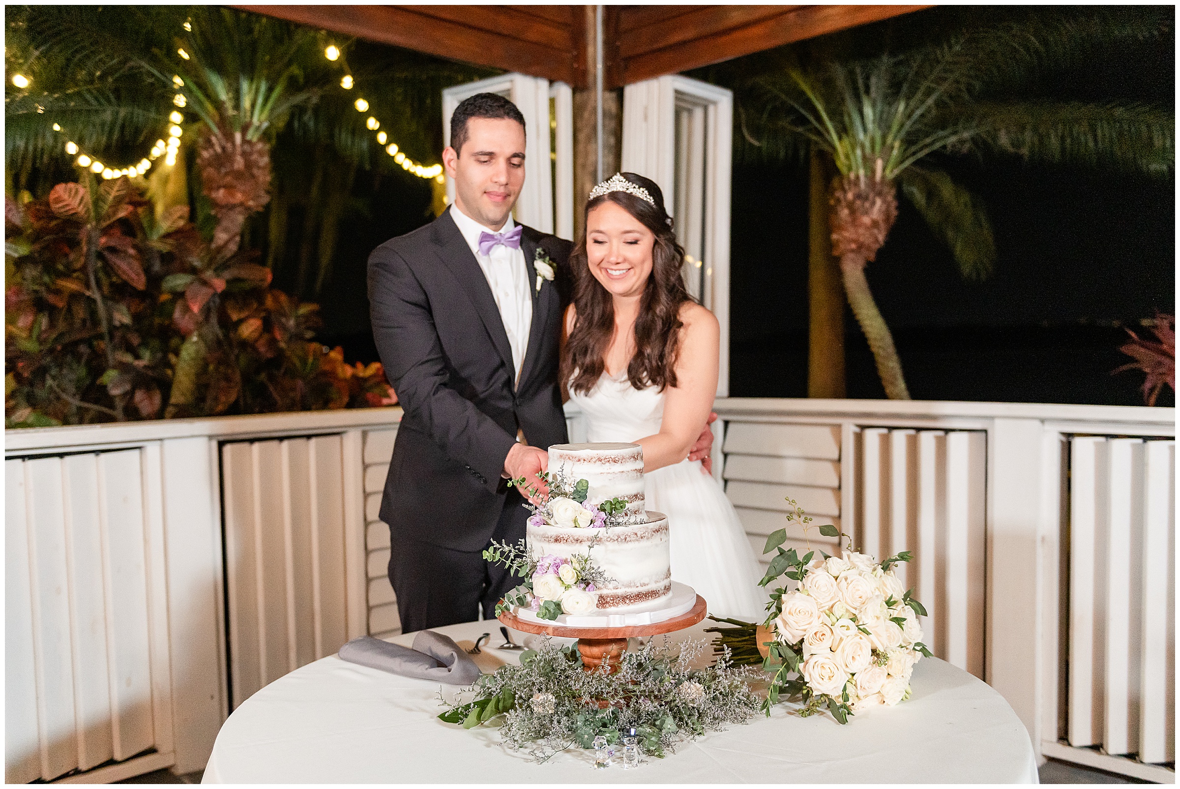 Bride and groom cutting wedding cake at their Paradise Cove Wedding in Orlando, FL