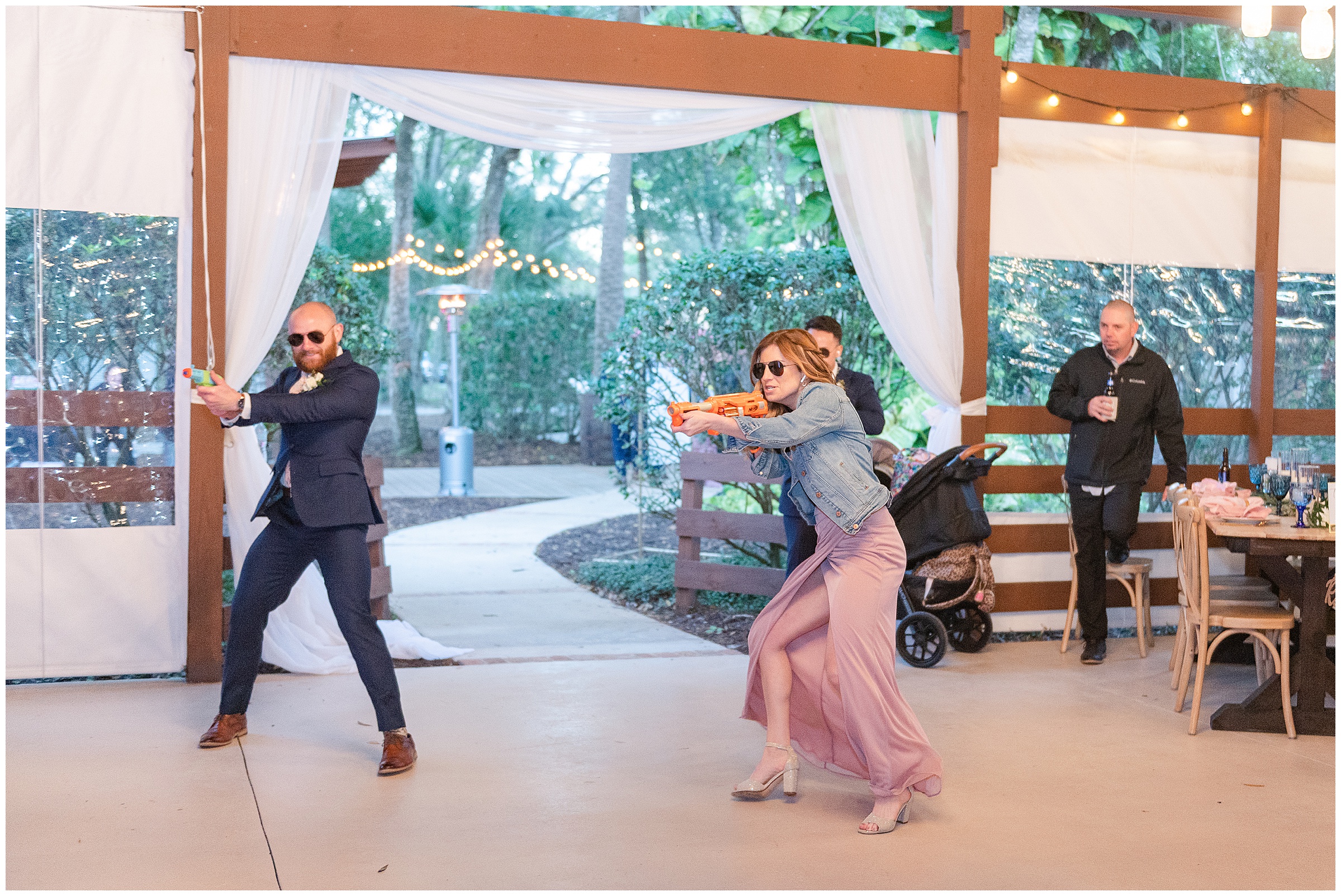 Fun bridal party reception entrance with nerf guns and sunglasses