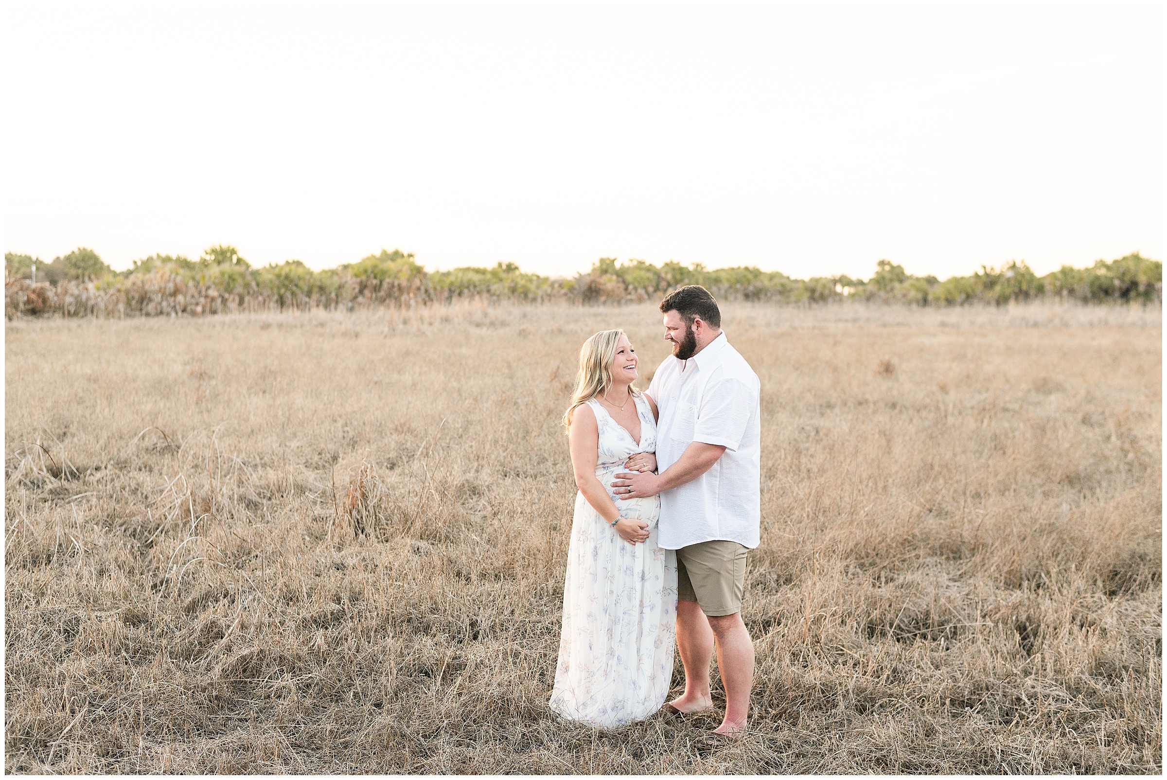 Maternity photos in a grassy field at Honeymoon Island State Park in Florida. 