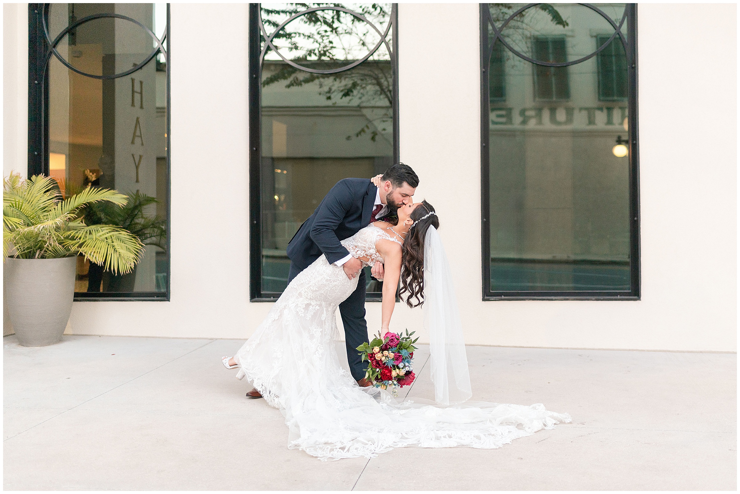 Bride and Groom Kissing and dipping out front of the Hotel Haya in Tampa, FL.