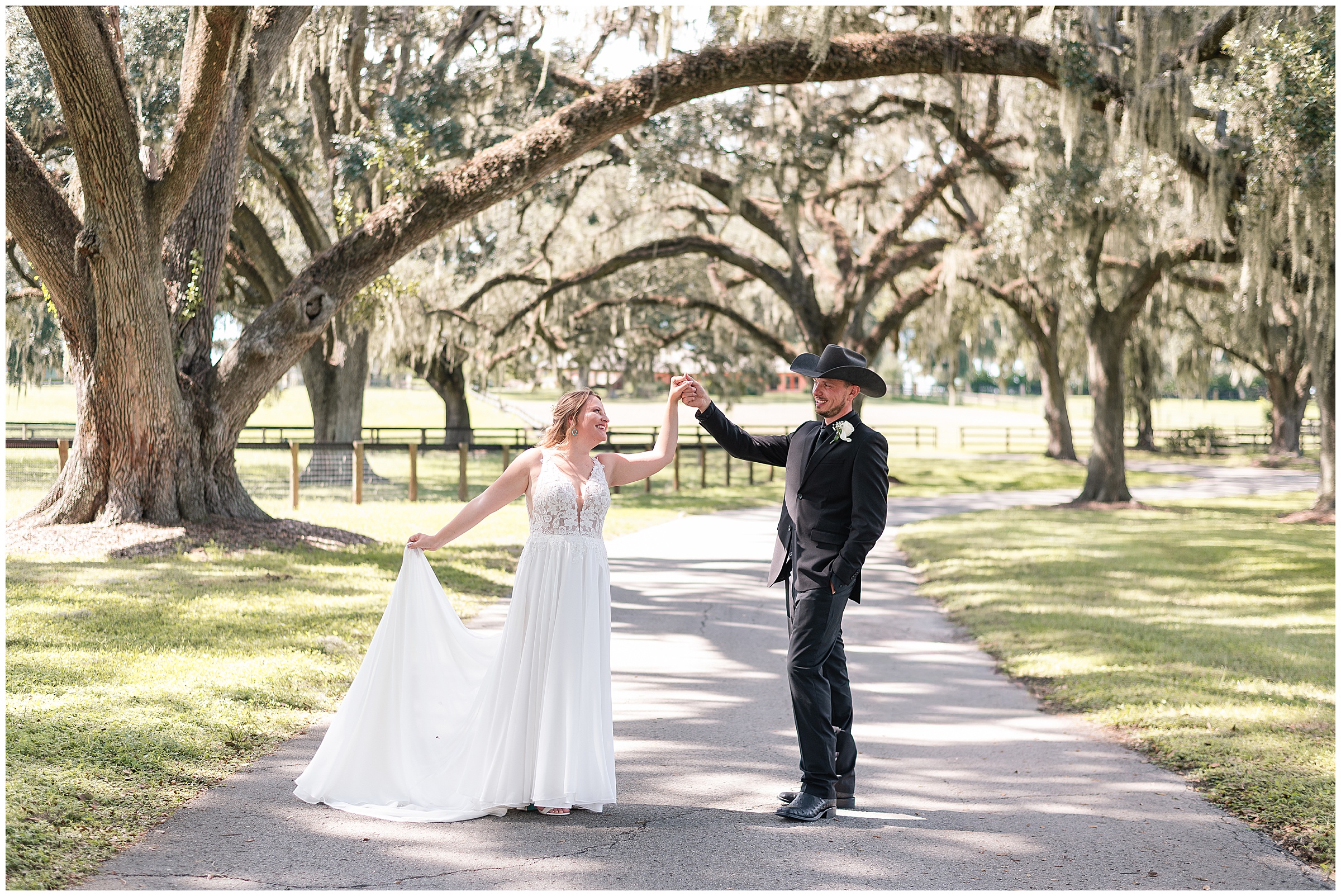 A bride and groom dancing and smiling at each other during their wedding photos at their Ocala Wedding at Protea Weddings and Events. 