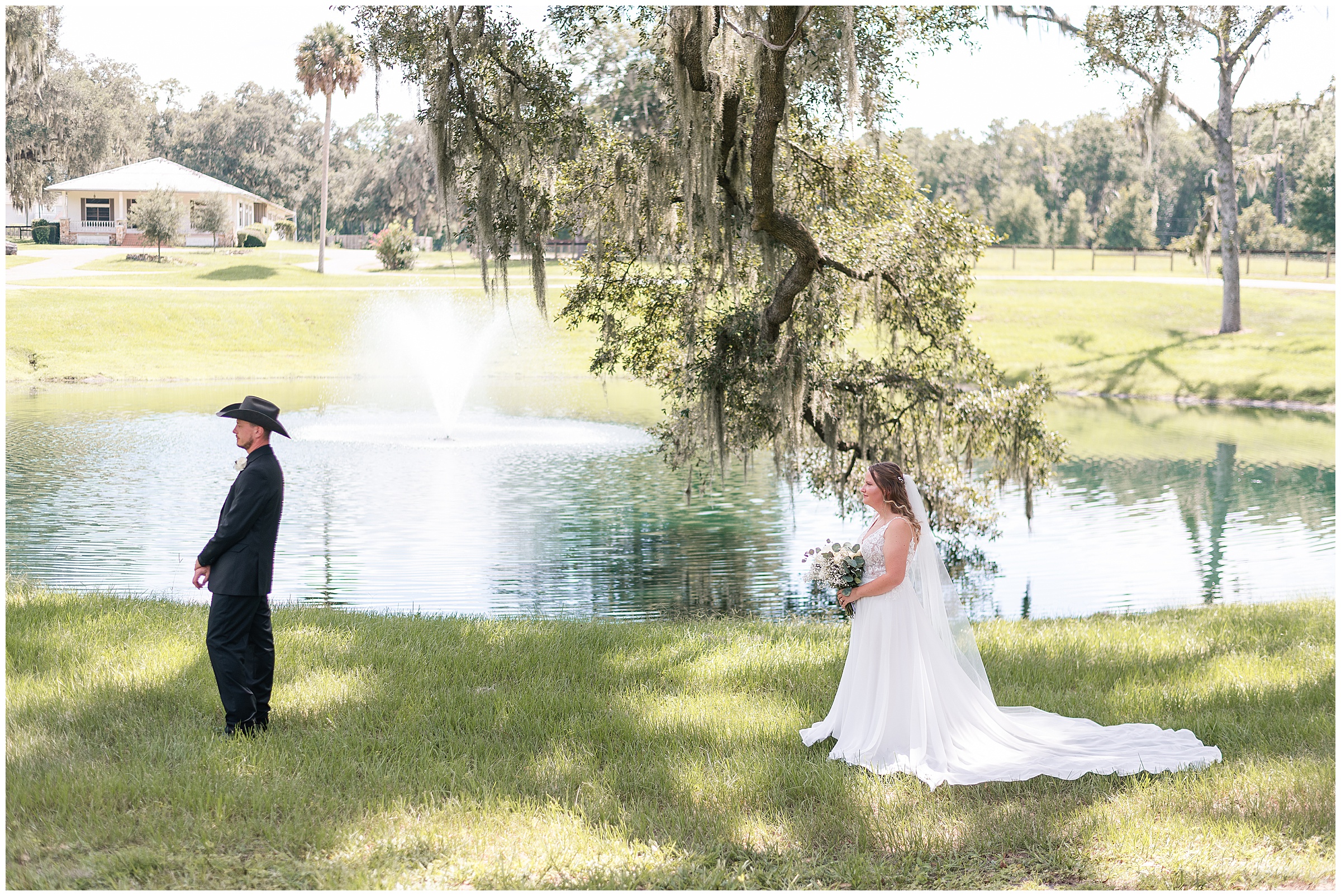 A bride and groom standing apart from each other getting ready to share their first look. They are standing in front of a pond at Protea Weddings and Events in Ocala, FL. 